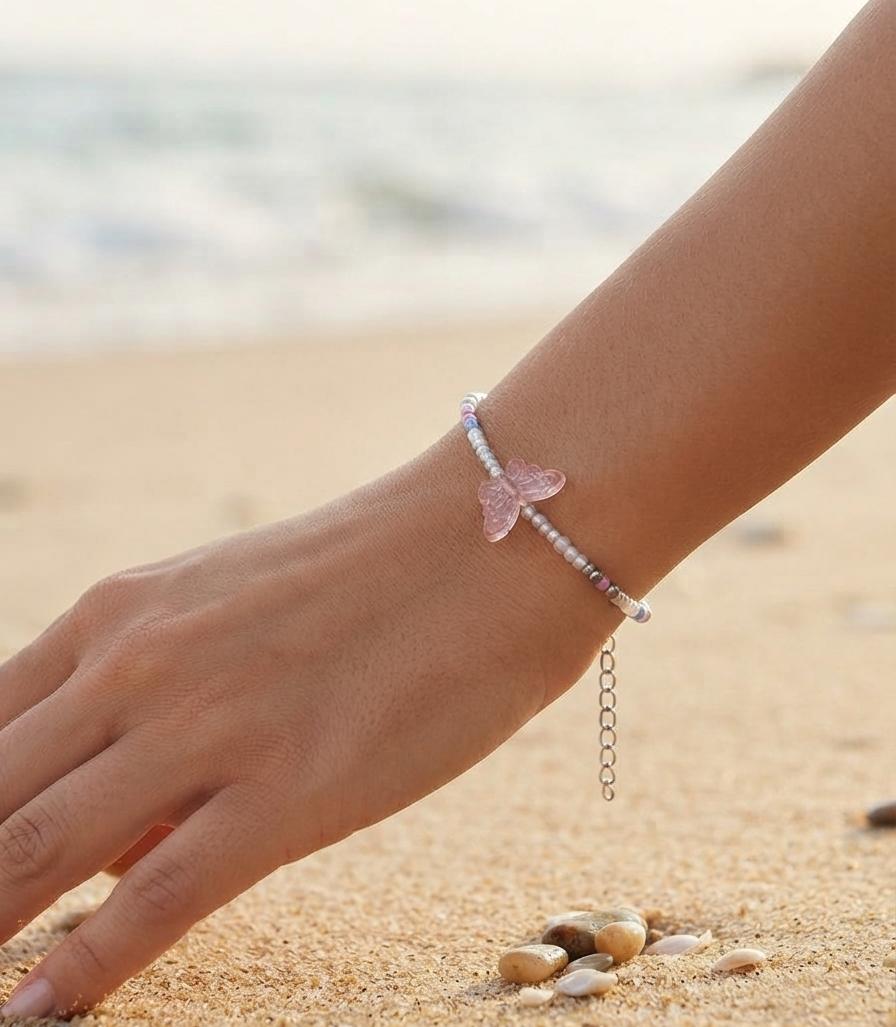 White bead bracelet with pink butterfly charm