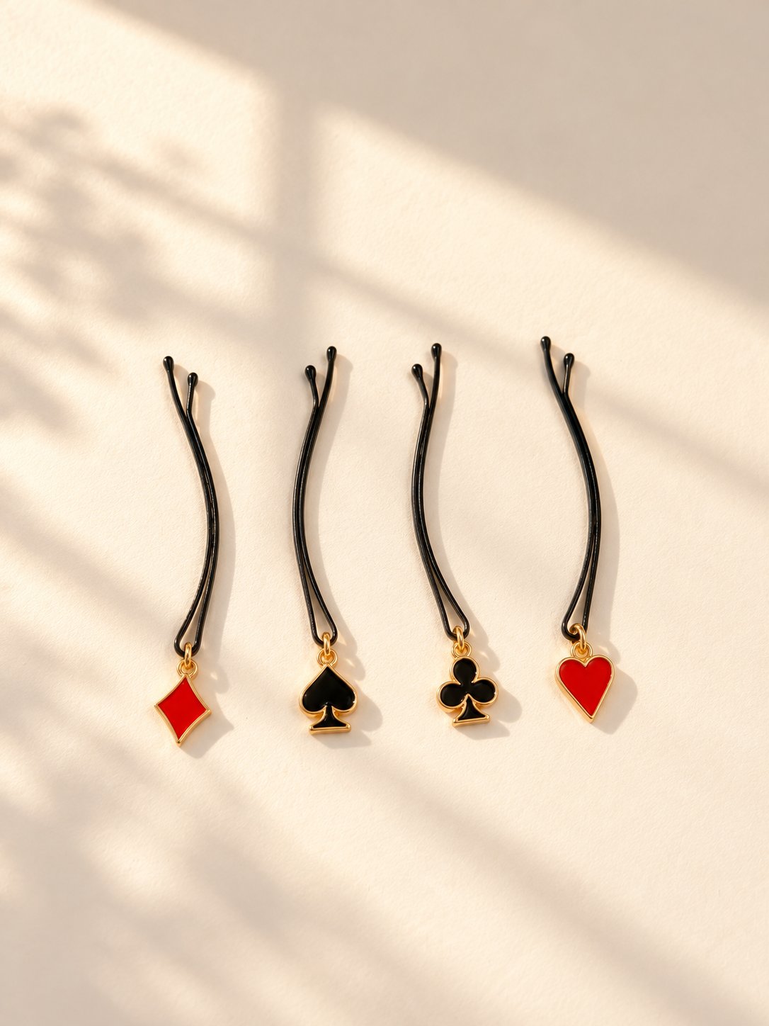 Playing card suit charm hair pins displayed individually