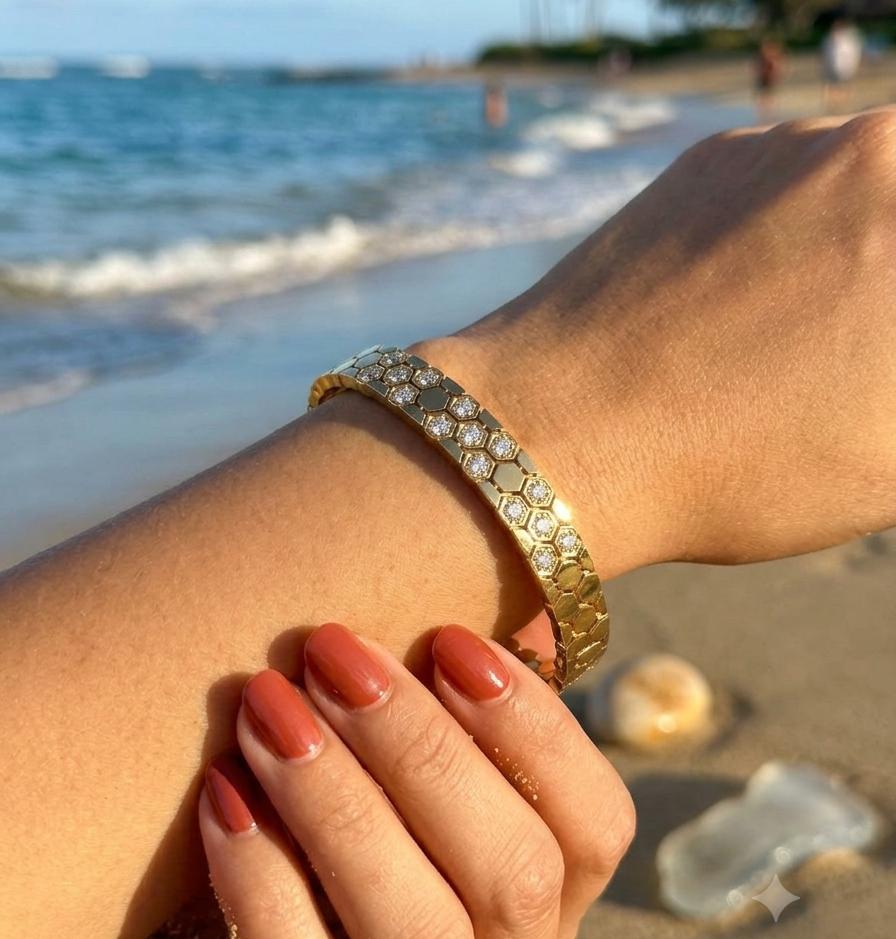 Gold honeycomb kada bracelet with clear stones, worn on wrist