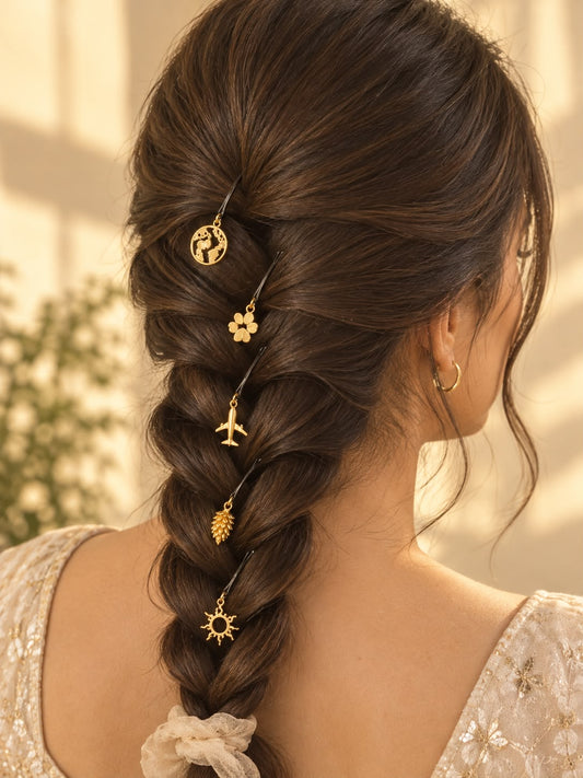Assorted gold charm hair pins styled in a braid