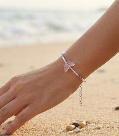 White bead bracelet with pink butterfly charm