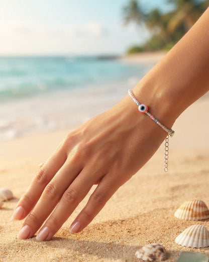 Pastel bead bracelet with blue evil eye charm