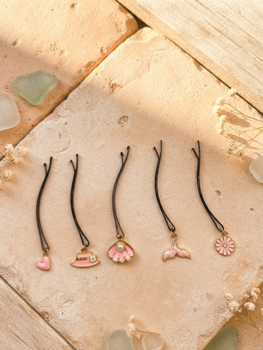 Five pink decorative hair pins displayed individually