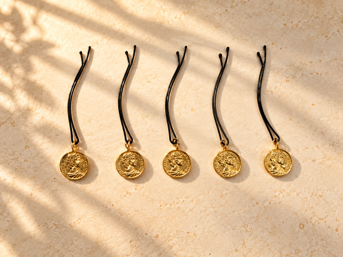 Five gold coin charm hair pins displayed individually