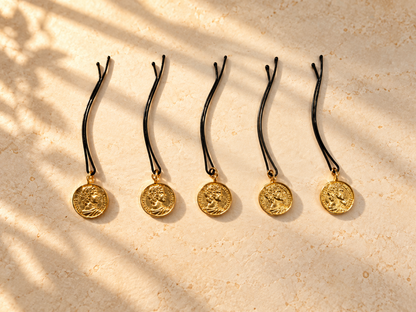 Five gold coin charm hair pins displayed individually