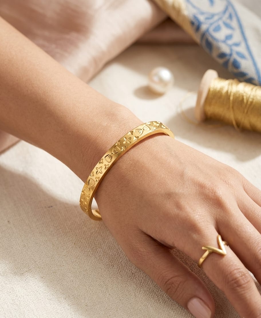 Gold-colour cuff bracelet with floral pattern