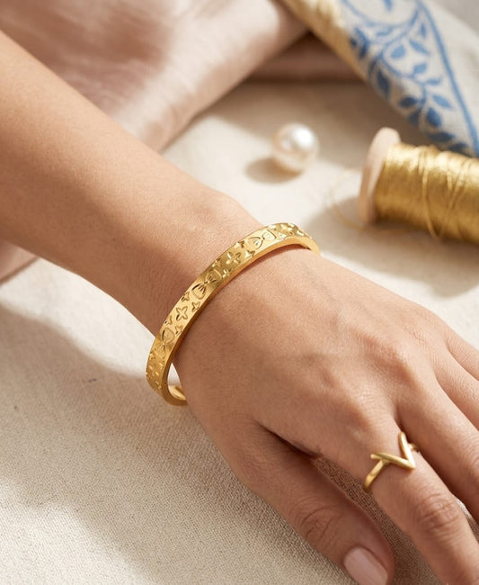 Gold-colour cuff bracelet with floral pattern