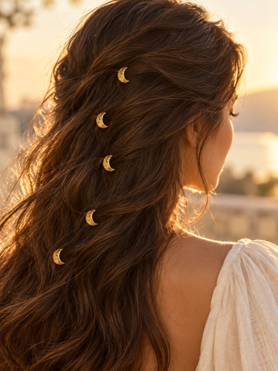 Gold glitter crescent hair pins styled in hair