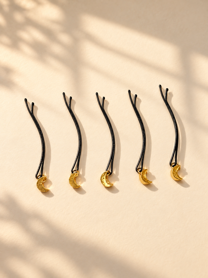 Gold glitter crescent hair pins displayed individually