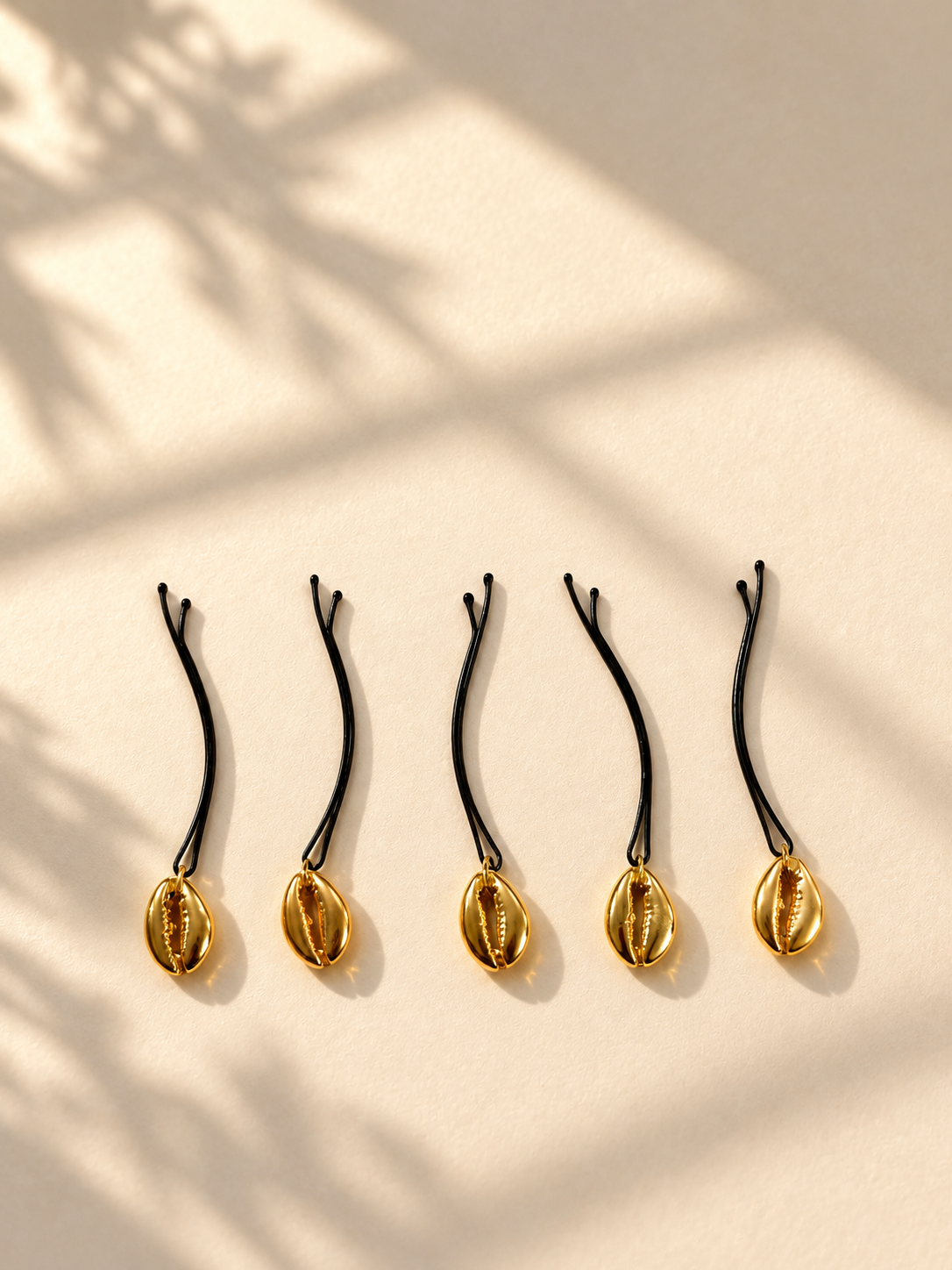 Gold shell charm hair pins displayed individually