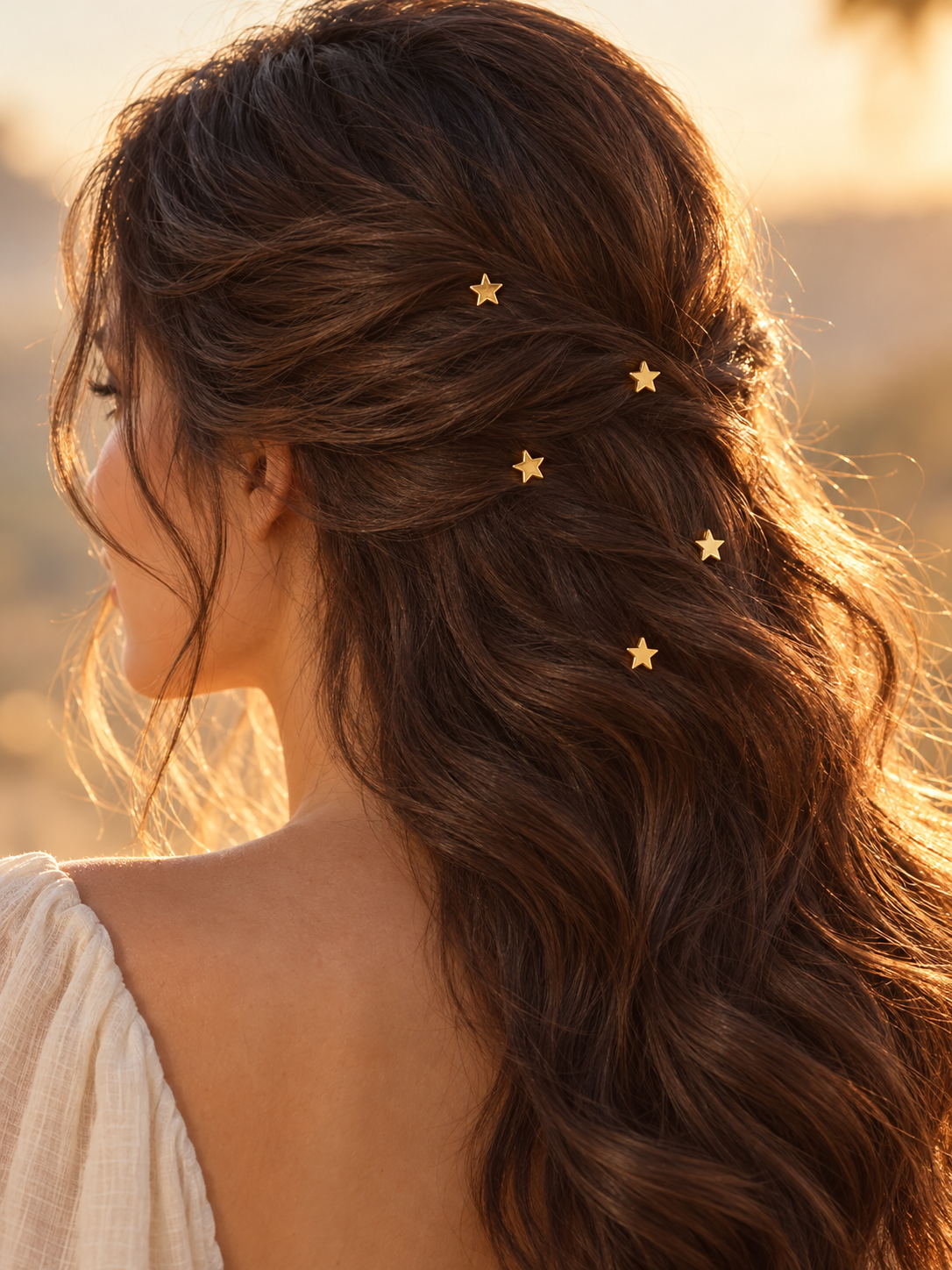 Gold star charm hair pins styled in hair
