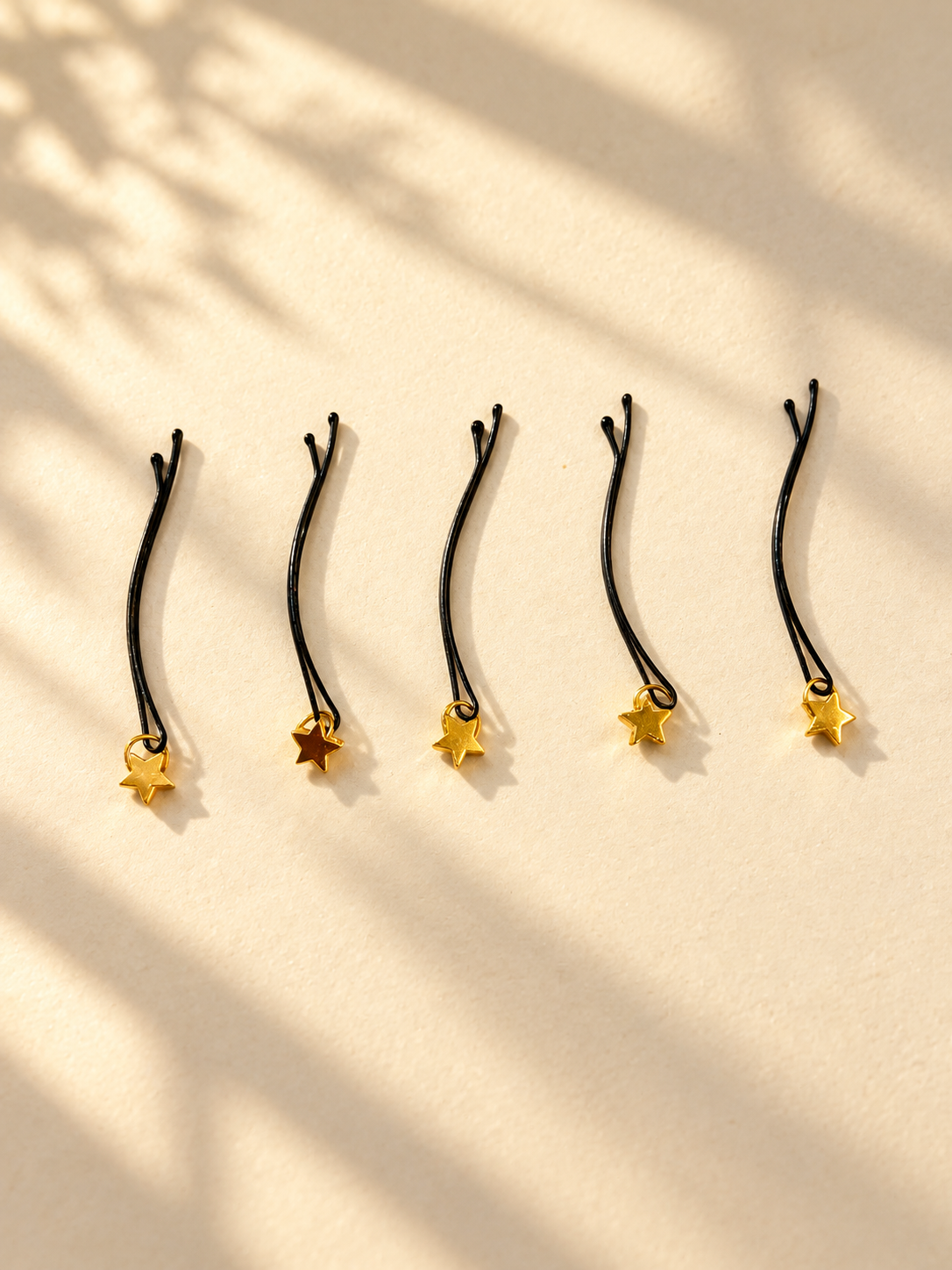 Gold star charm hair pins displayed individually