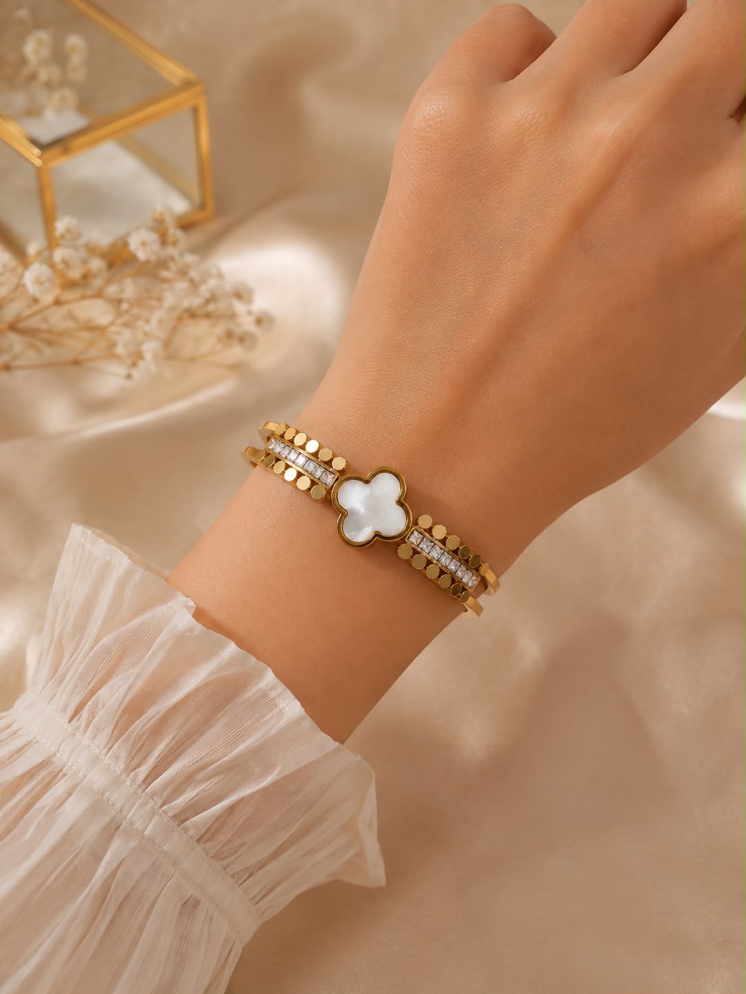Gold-colour small kada with white flower centre and clear stone details
