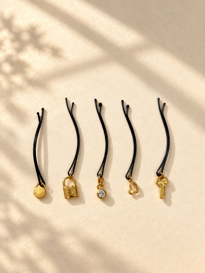 Five assorted lock and key charm hair pins displayed individually