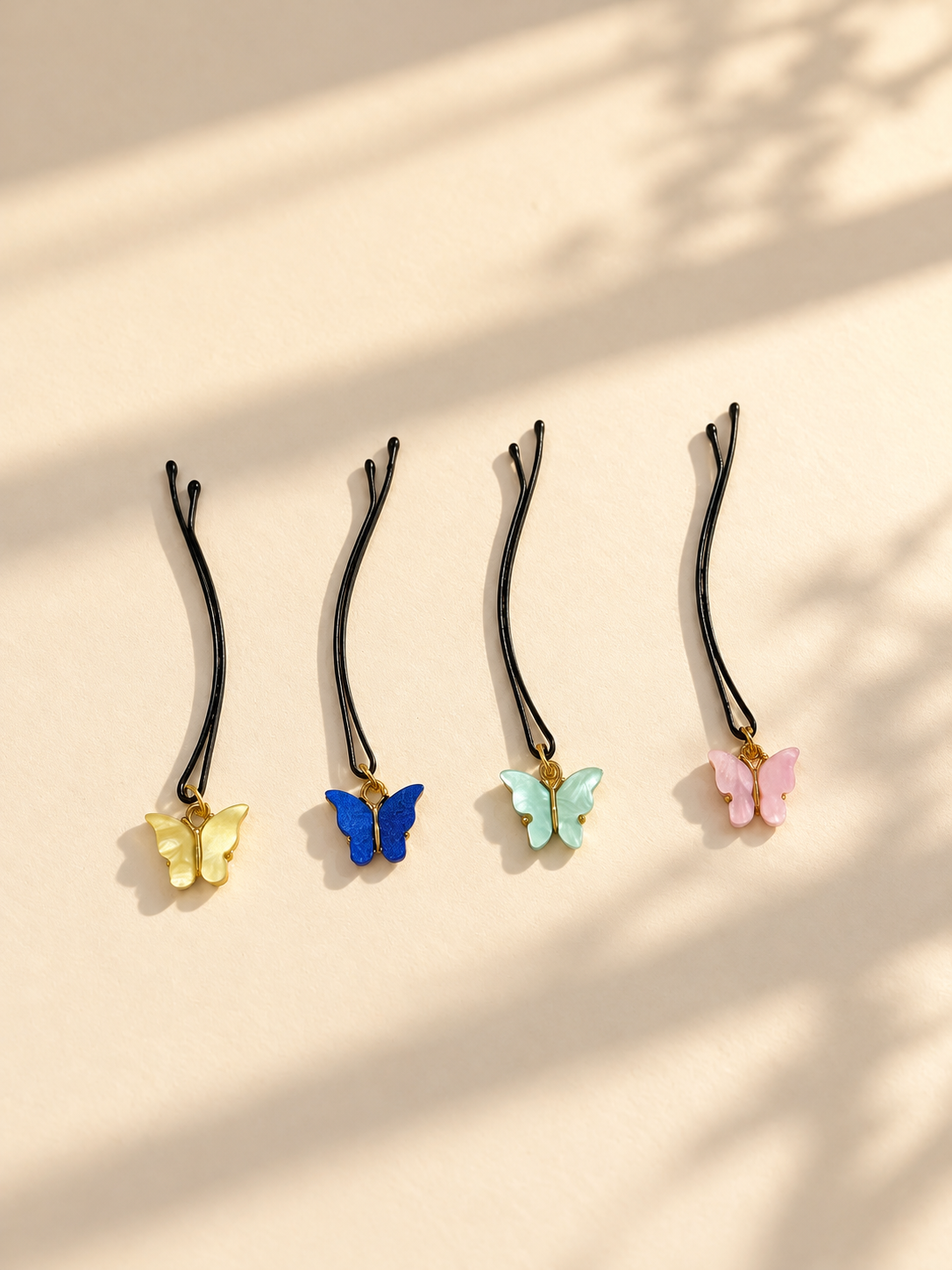 Pastel butterfly charm hair pins displayed individually