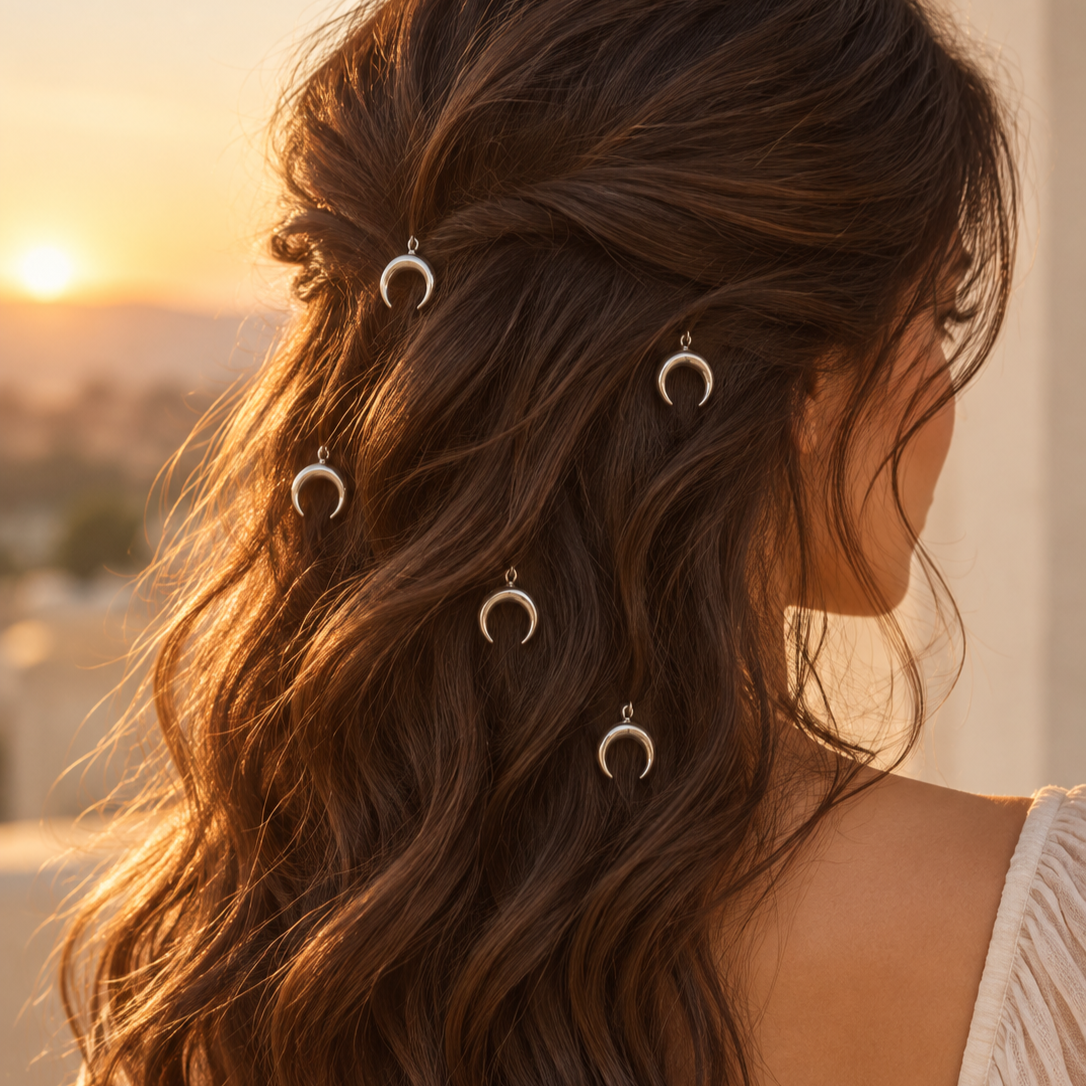 Silver crescent charm hair pins styled in hair
