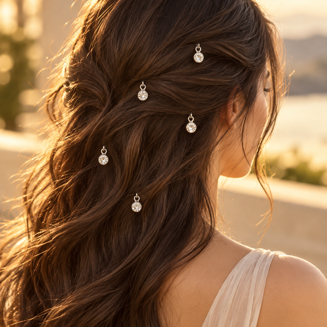 Silver crystal-look charm hair pins styled in hair